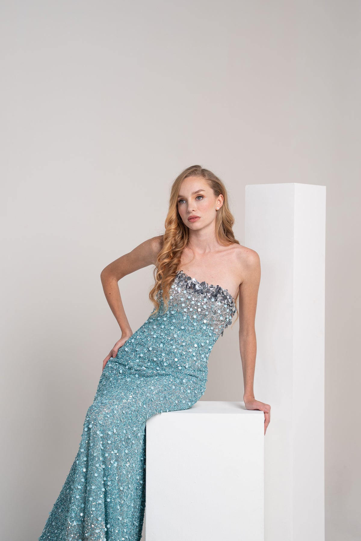 Turquoise sequined dress with sliver accents on the top and bottom.