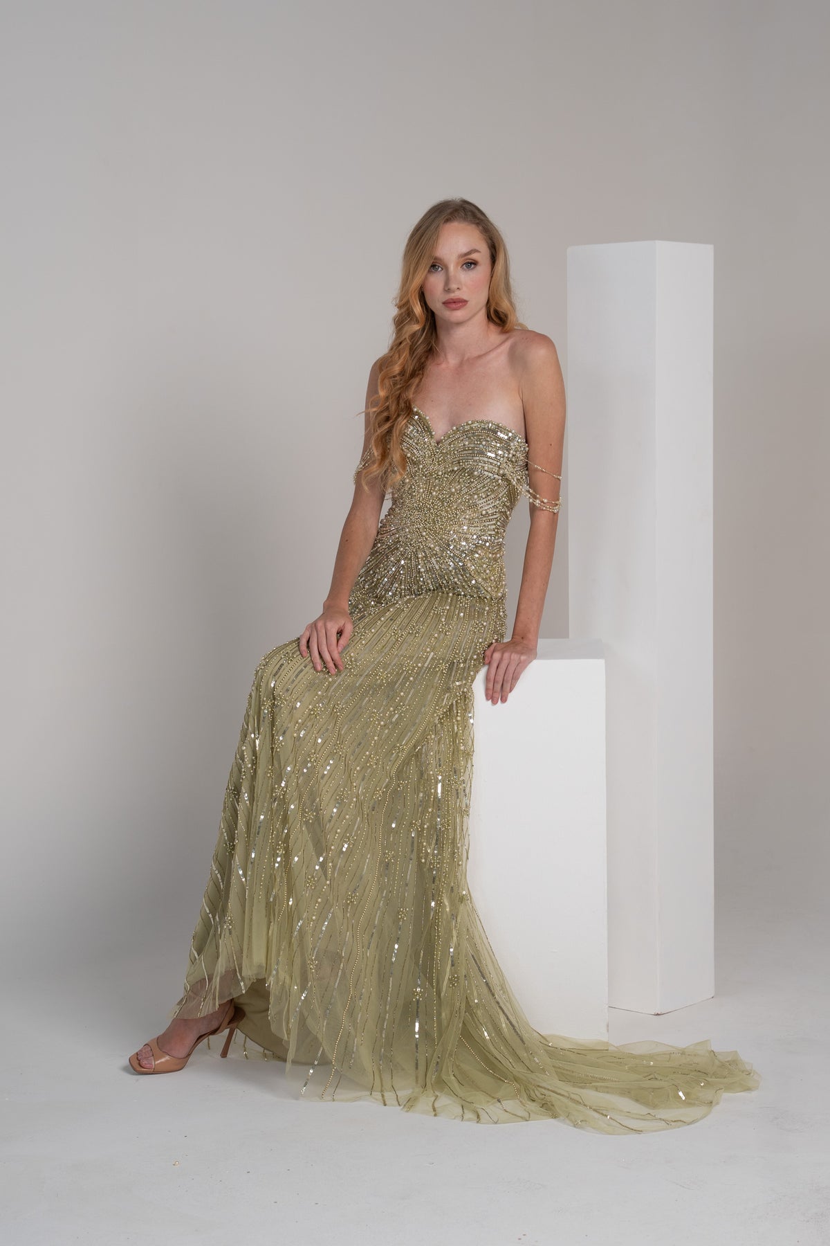 green fully beaded dress with pearl accents and embroidered lines on the skirt.