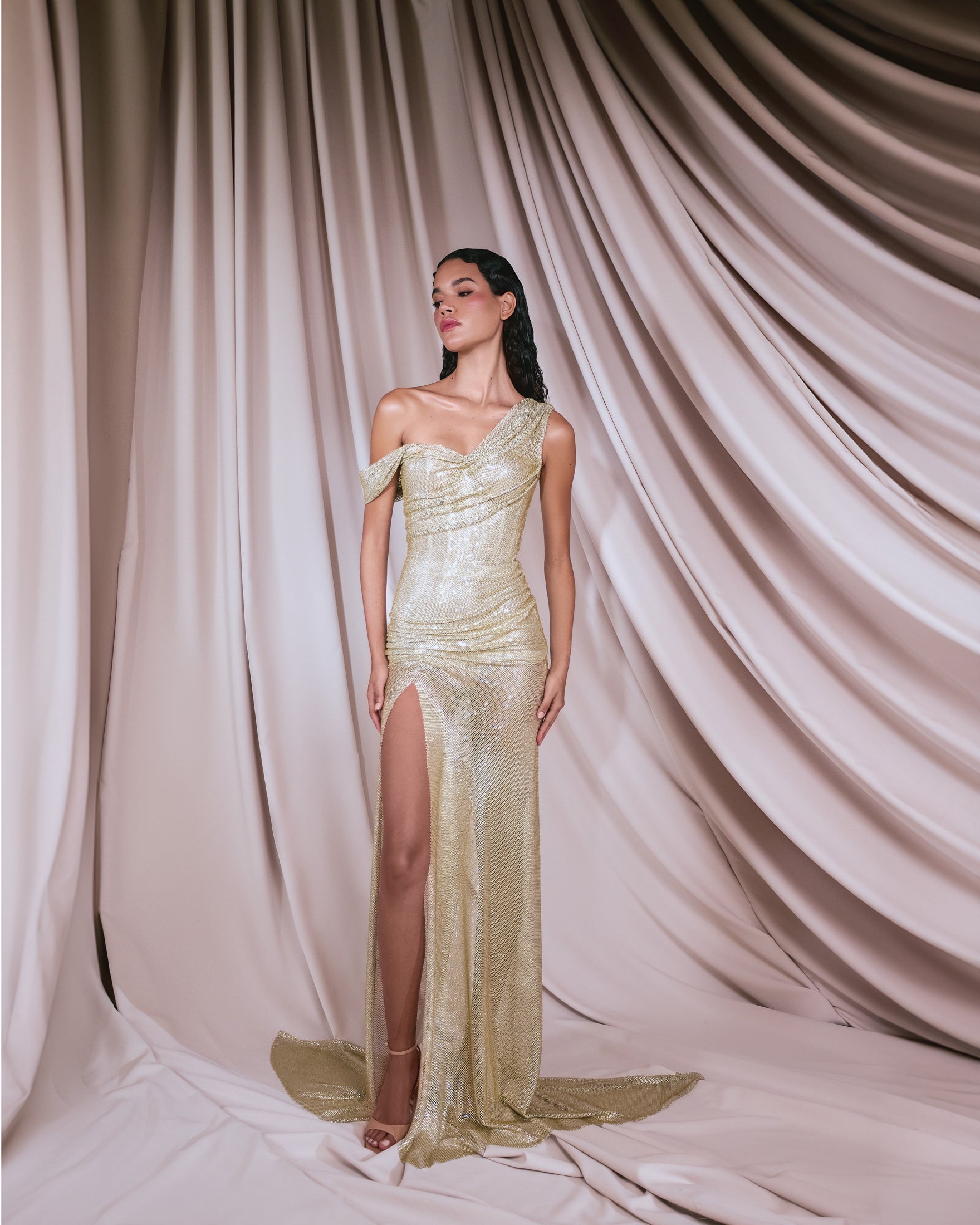 Crystal gold mesh draped in a fitted dress