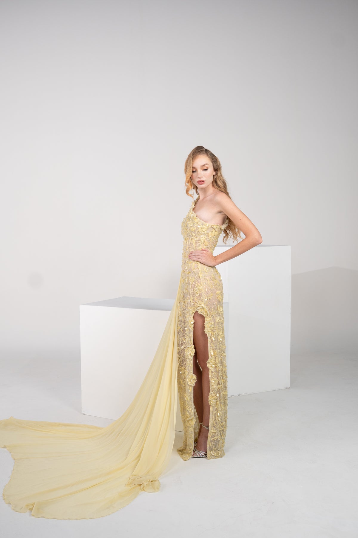 A yellow floral gown with delicate chiffon on the side and side slit.
