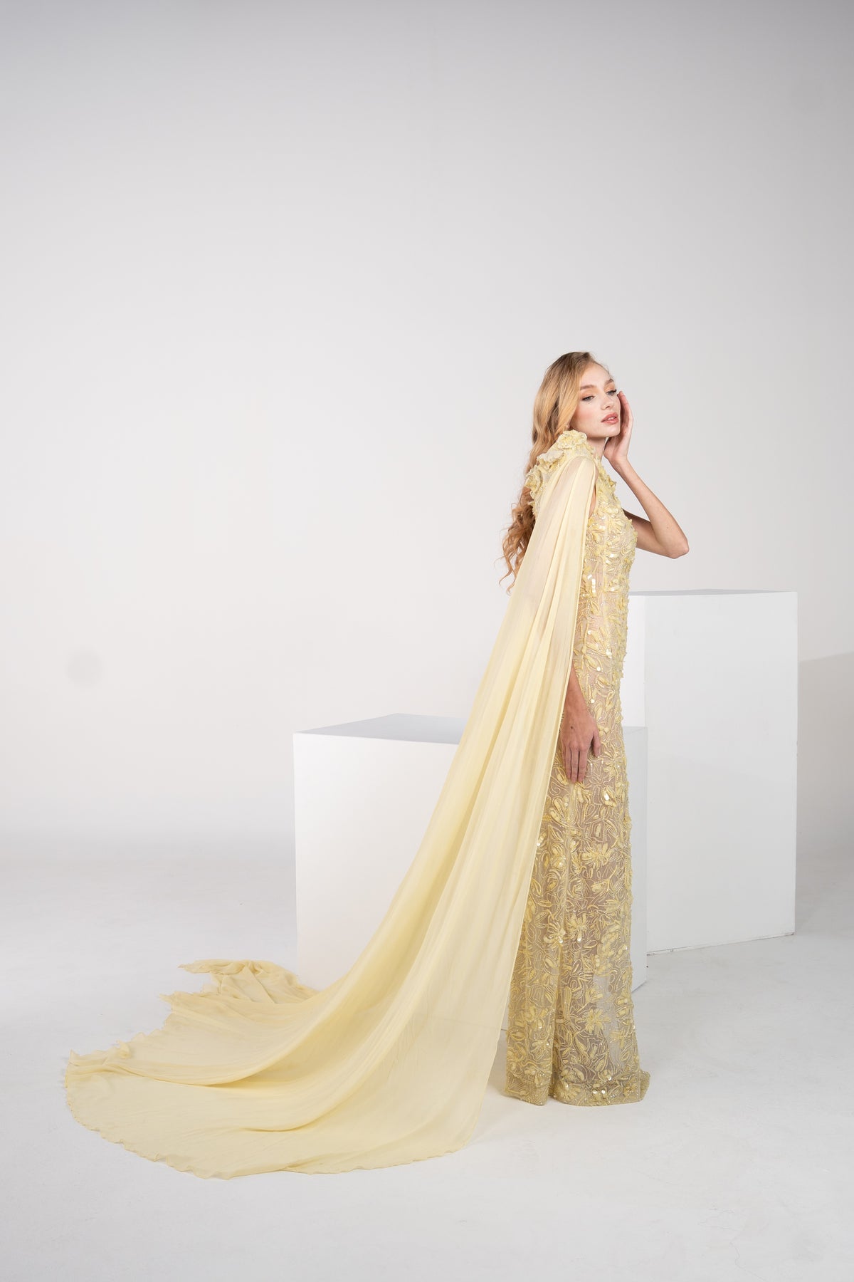 A yellow floral gown with delicate chiffon on the side and side slit.