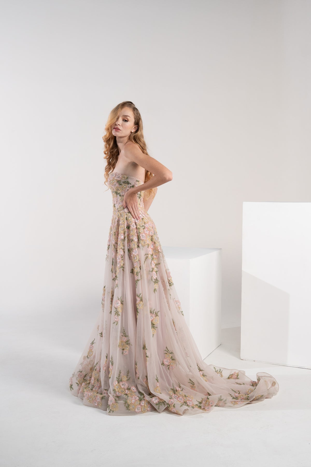 A pink puffy dress adorned with delicate pink and green flowers.