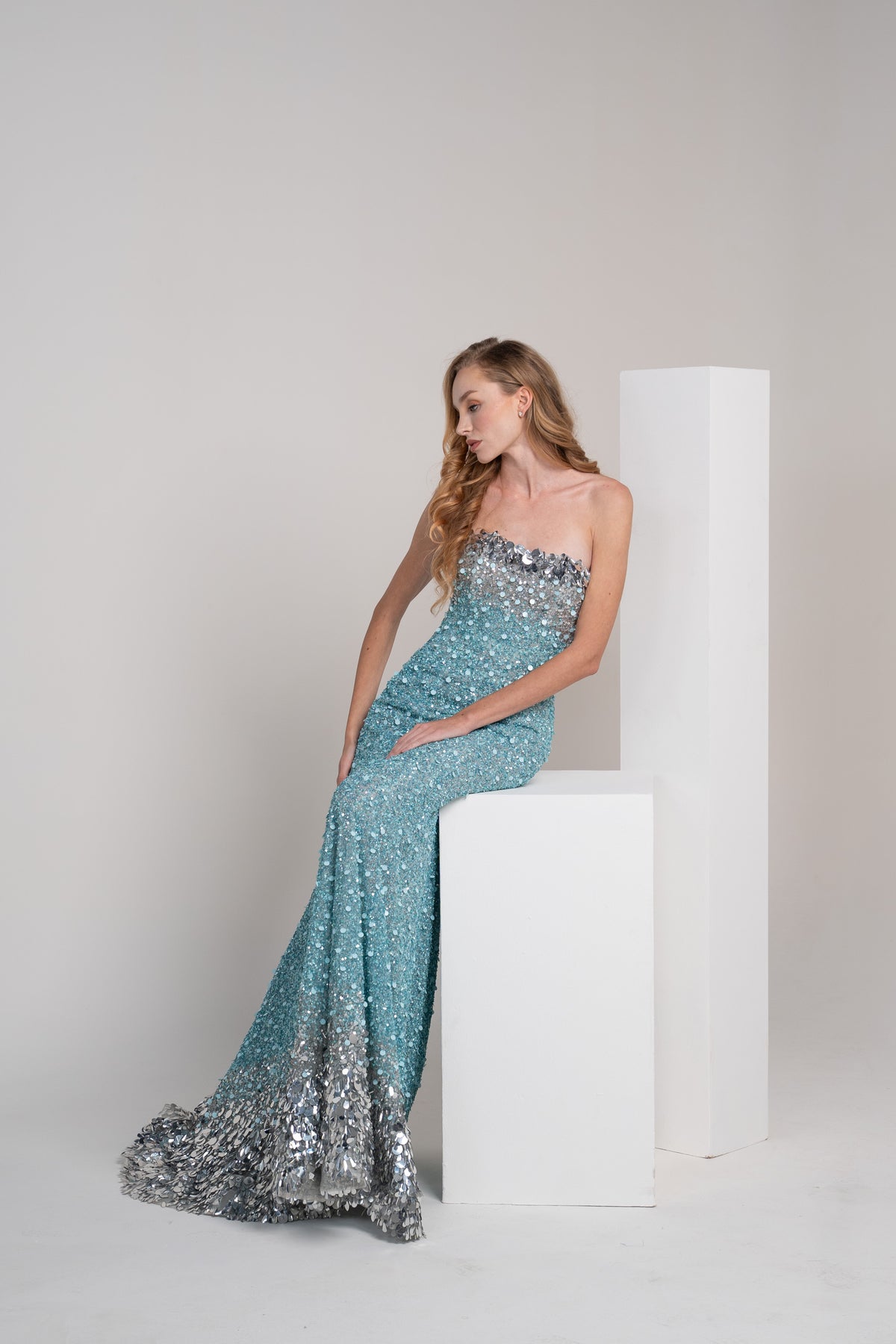 Turquoise sequined dress with sliver accents on the top and bottom.