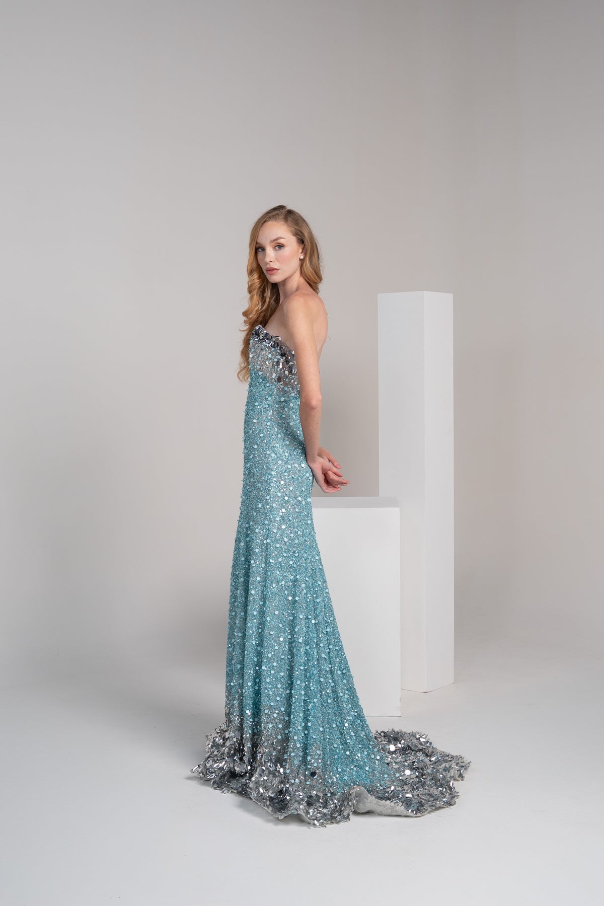 Turquoise sequined dress with sliver accents on the top and bottom.