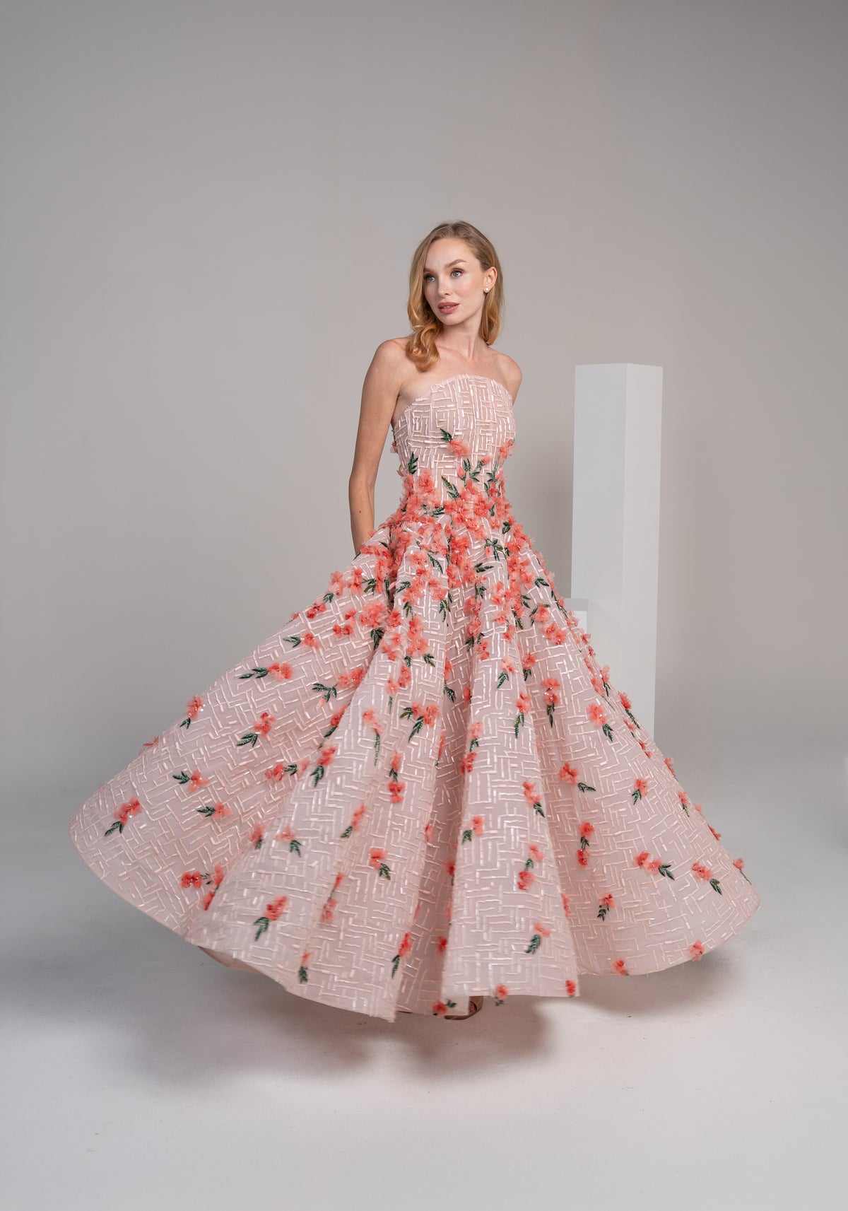 structured pink puffy dress adorned with delicate 3D flowers