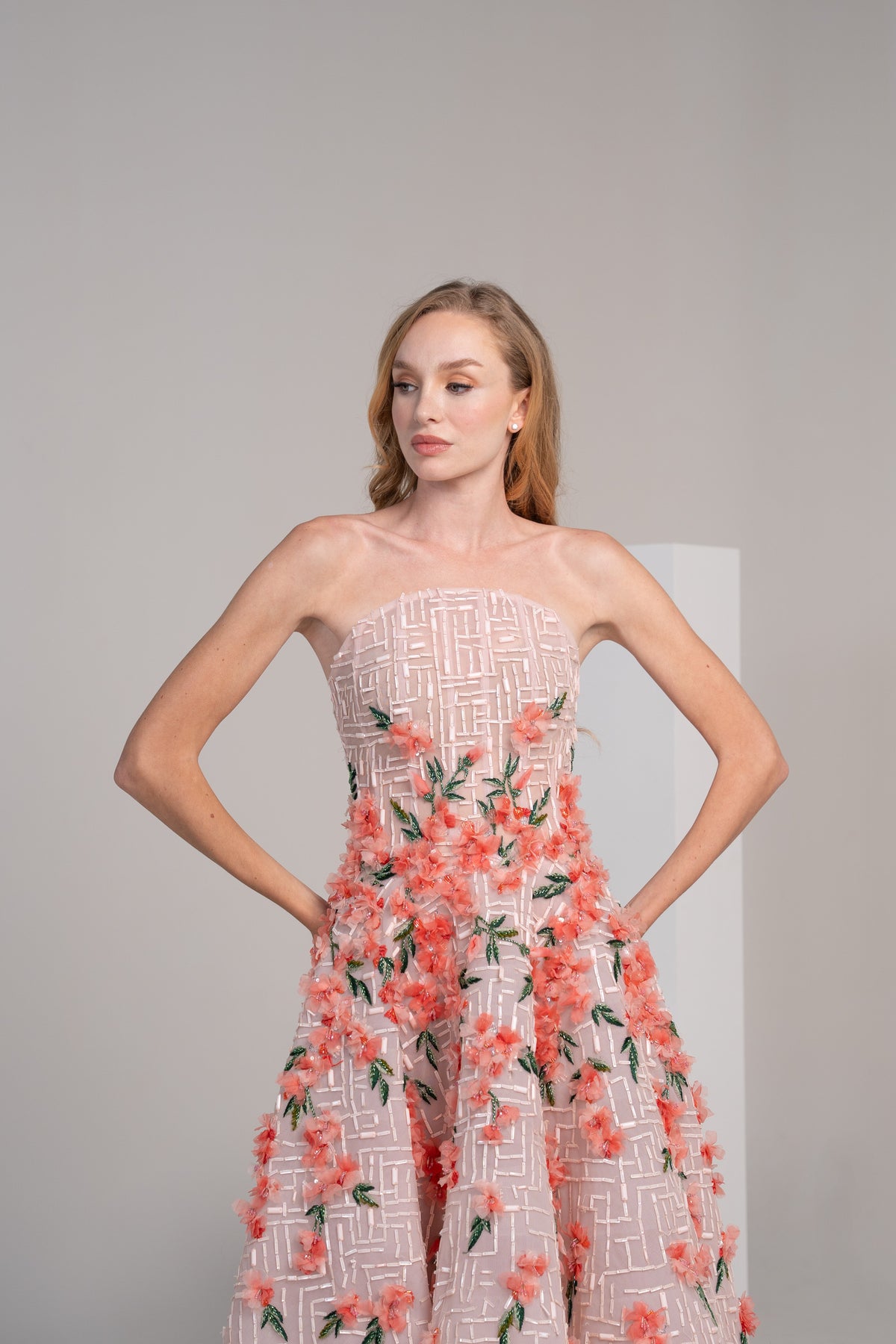 structured pink puffy dress adorned with delicate 3D flowers