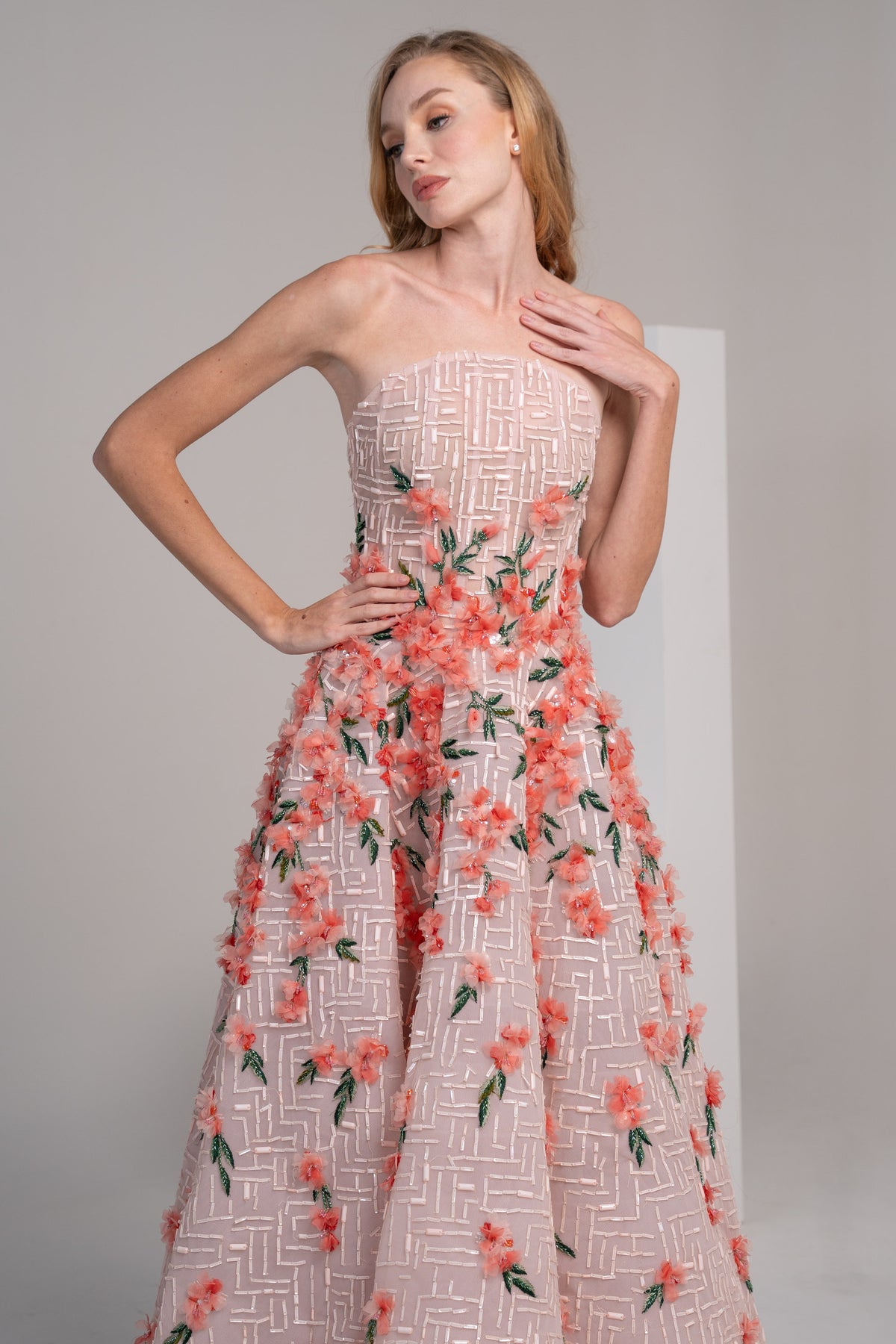 structured pink puffy dress adorned with delicate 3D flowers