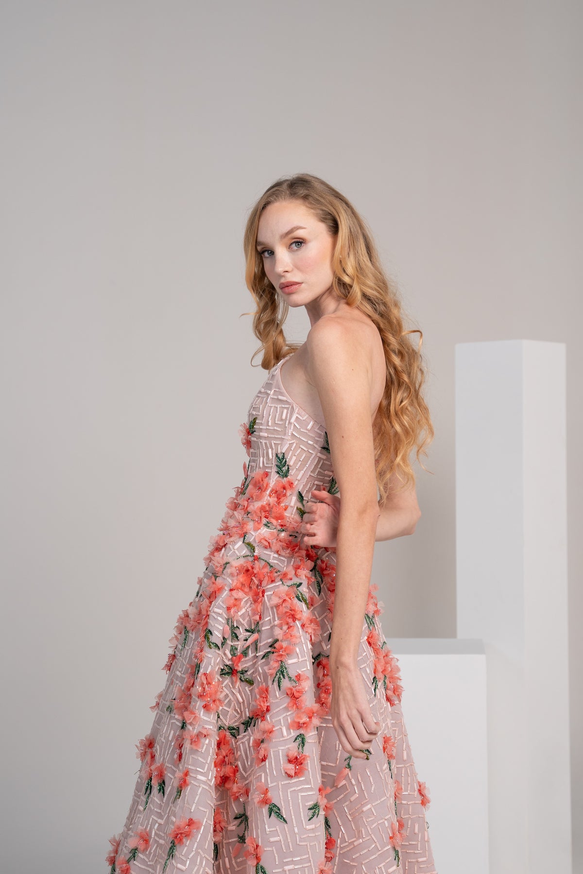 structured pink puffy dress adorned with delicate 3D flowers