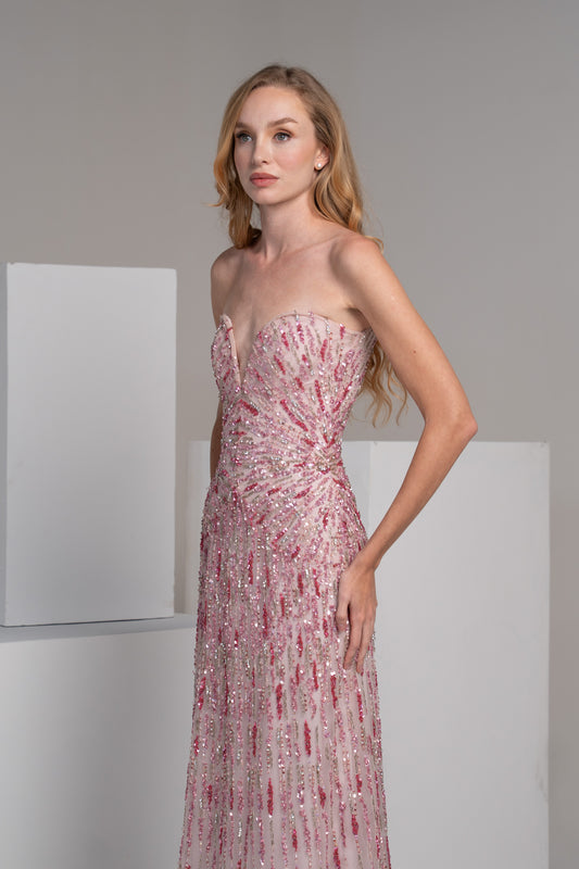 Pink dress with radiating embroidery lines that accentuate the waist.