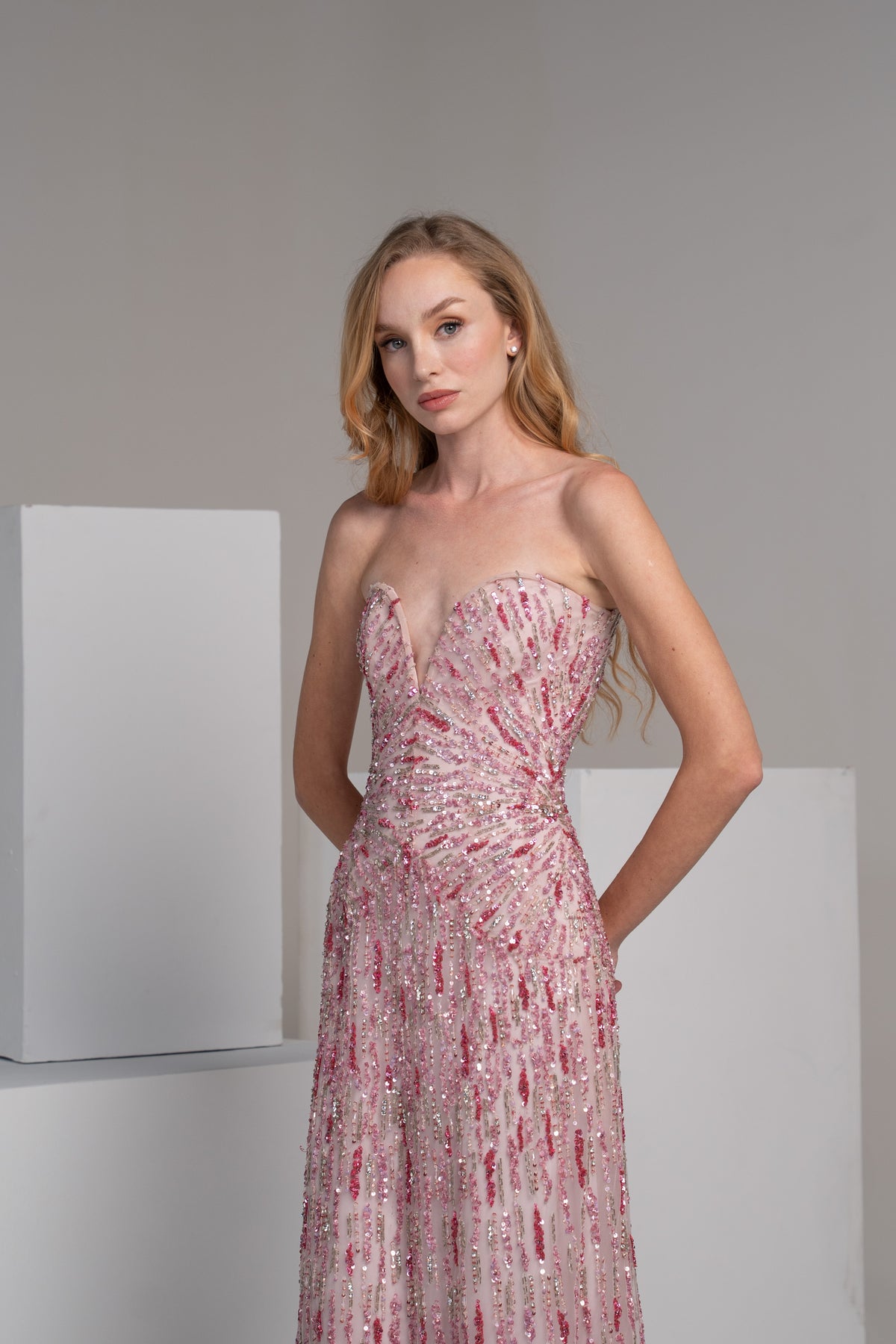 Pink dress with radiating embroidery lines that accentuate the waist.