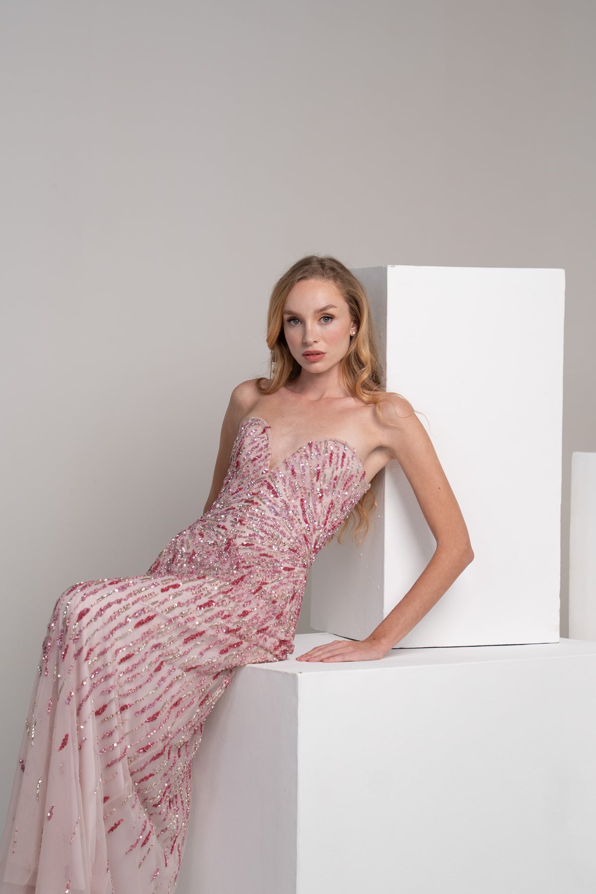 Pink dress with radiating embroidery lines that accentuate the waist.